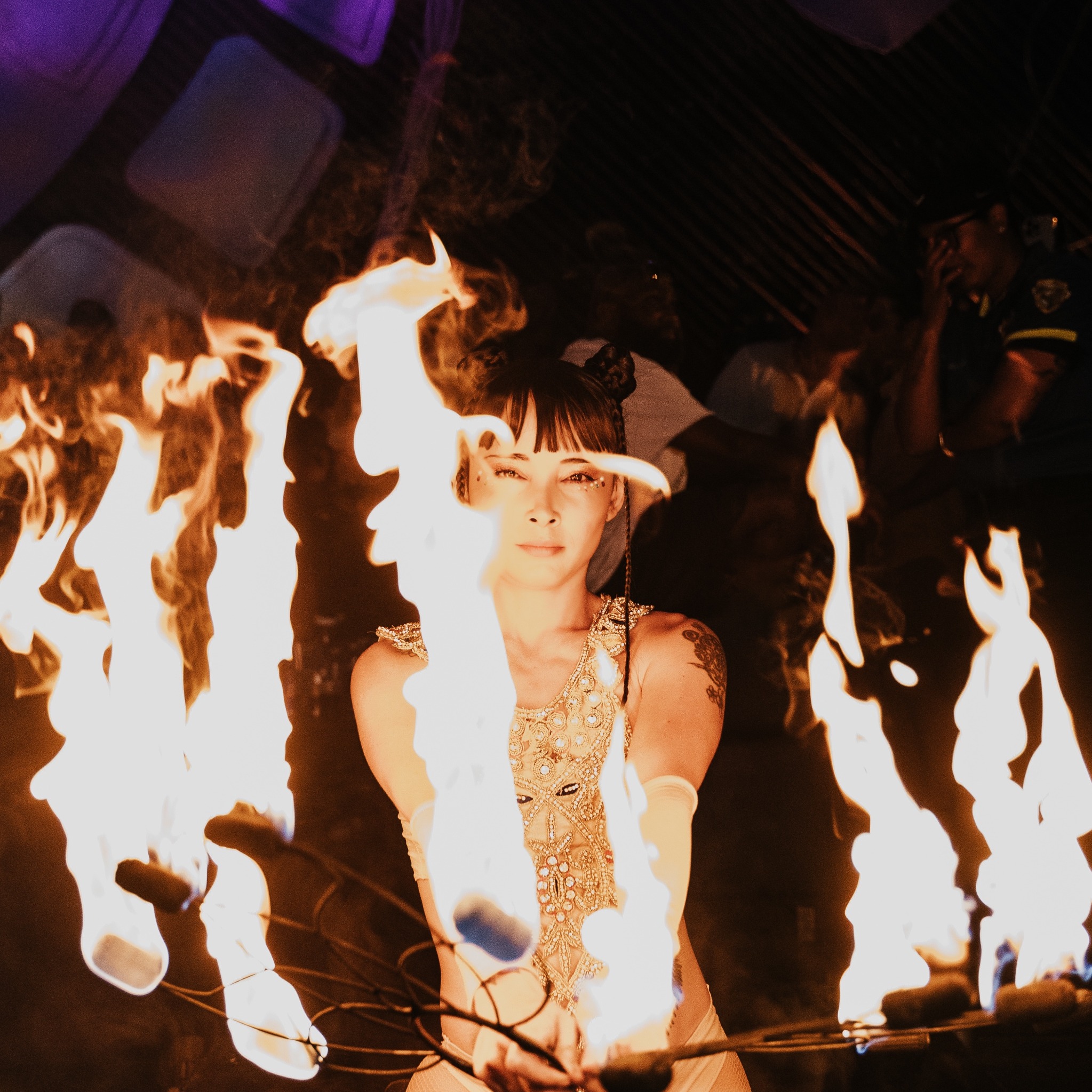 Jawara framed by a circle of flames during a performance