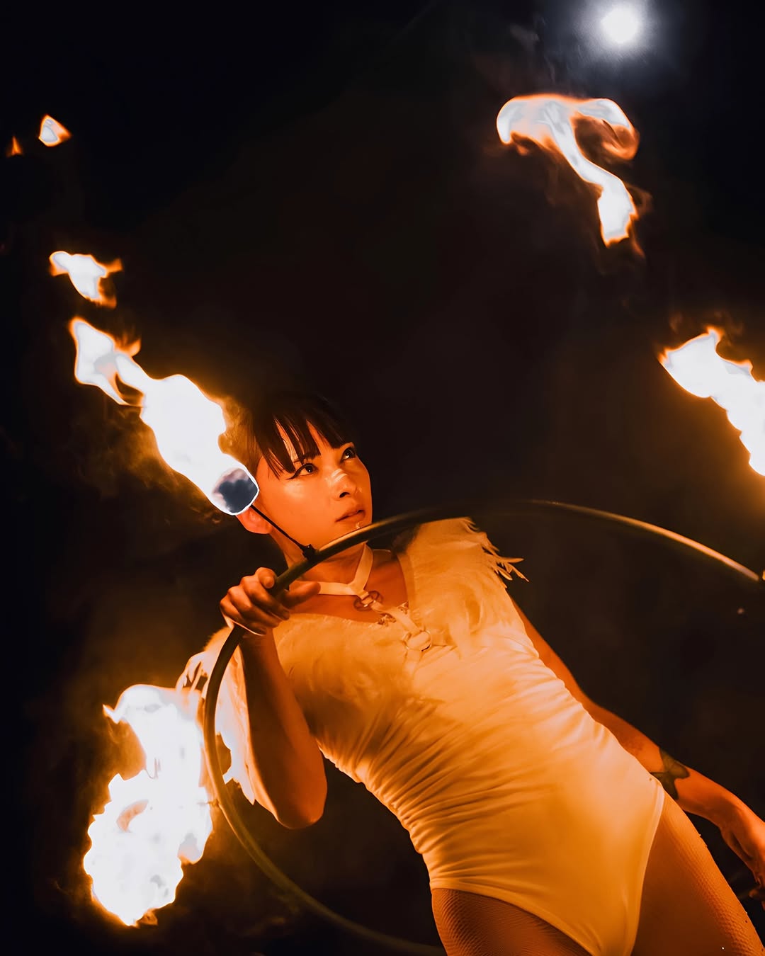 JAWARA performing a fire show with a fire hoop